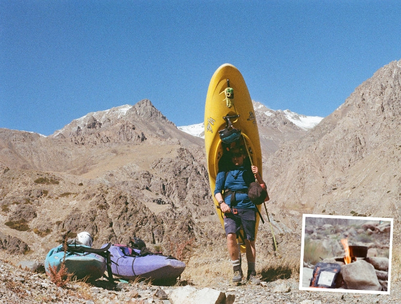 Tom with his kayak on his back for a portage in Tian Shan